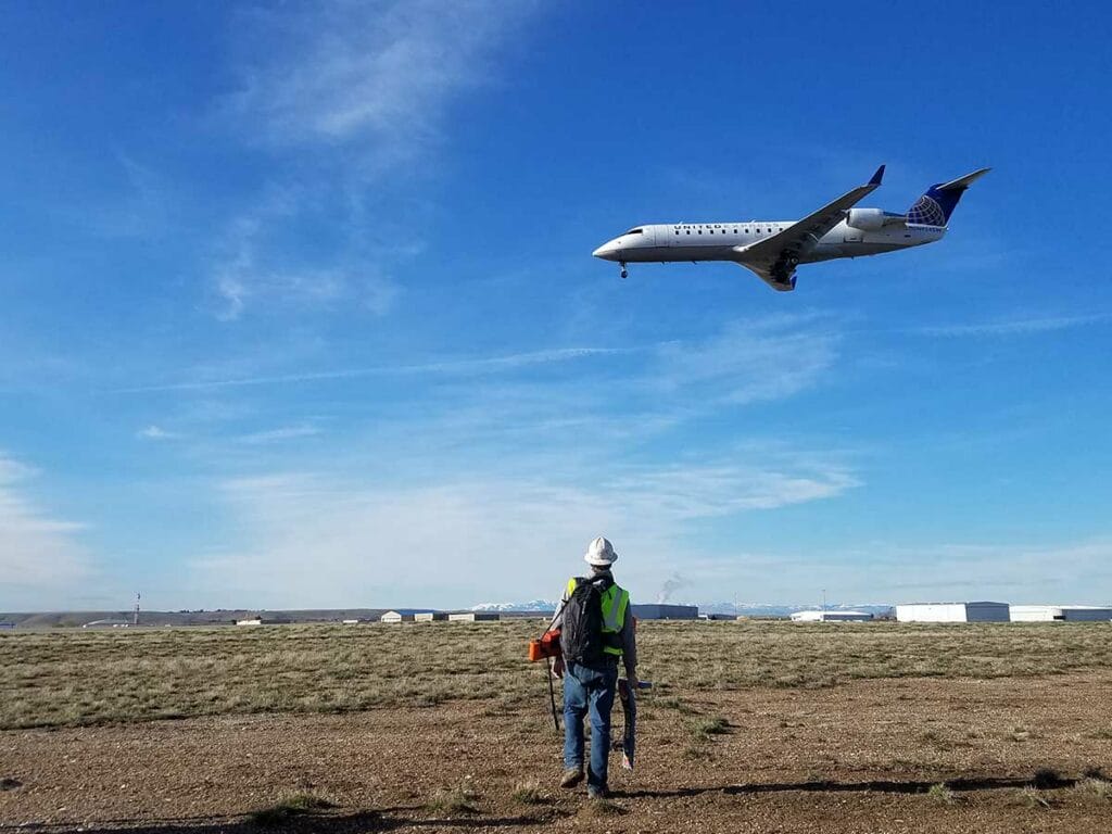 Man walking beneath commercial jet